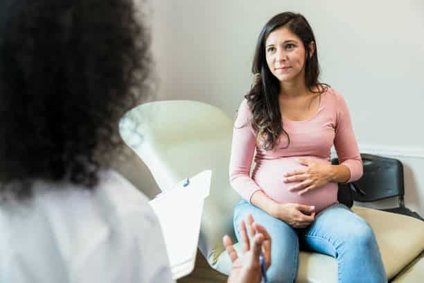 pregnant woman is having a one on one consultation with a doctor 