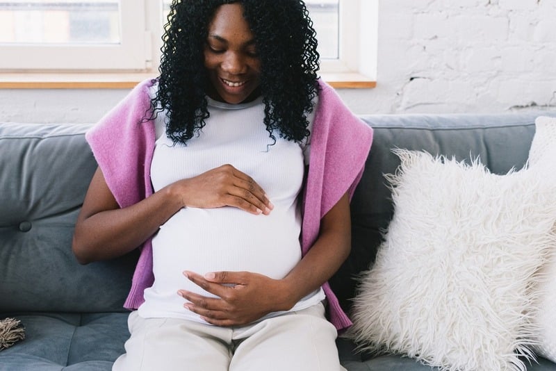 Pregnant woman holding her tummy